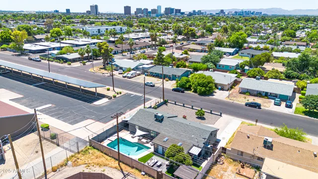 an aerial view of residential houses with city view