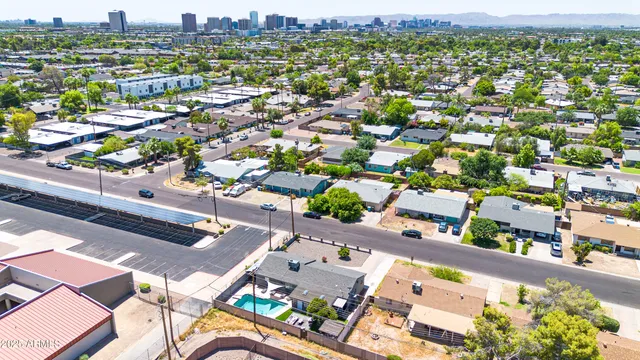 an aerial view of residential houses with outdoor space and street view