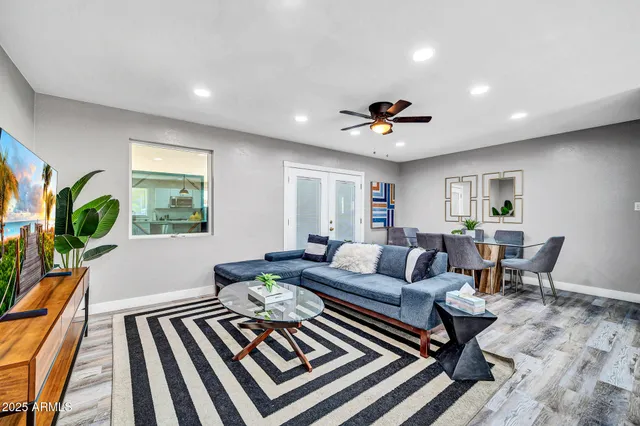 a living room with furniture and a chandelier
