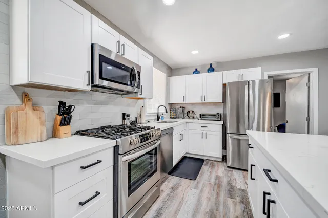 a kitchen with a stove a sink and a microwave
