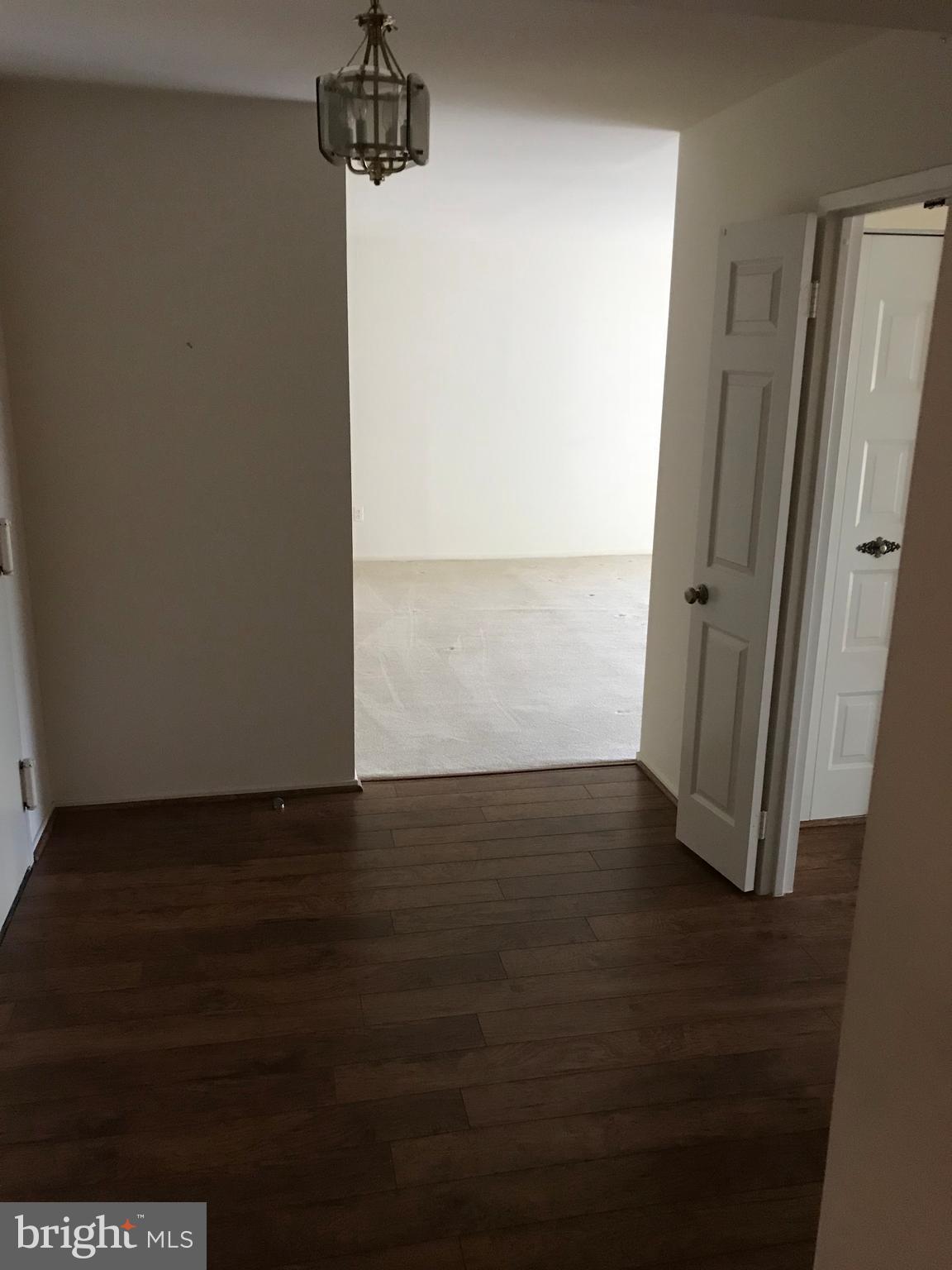 2817 Jermantown Road, Unit 203 Oakton, VA 22124 - Photo 11 of 22 an empty room with wooden floor sink and window
