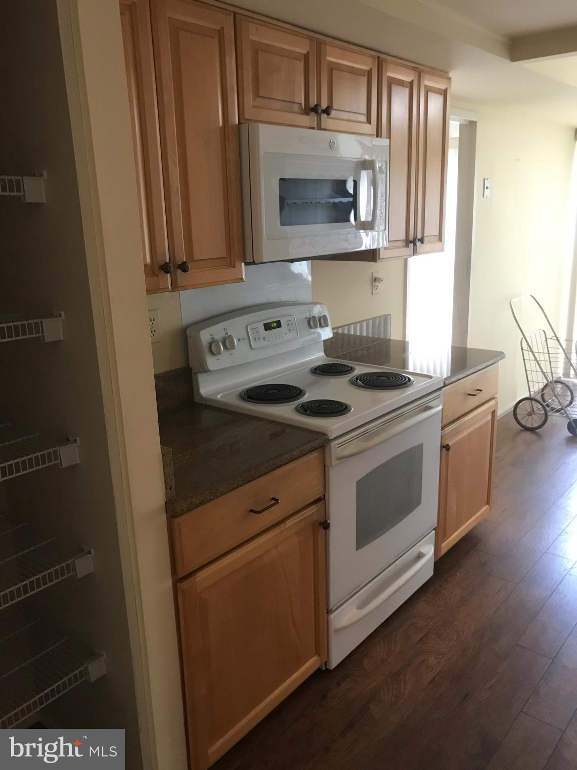 2817 Jermantown Road, Unit 203 Oakton, VA 22124 - Photo 7 of 22 a kitchen with a stove microwave and sink