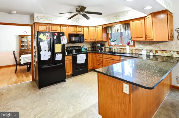 a kitchen with stainless steel appliances granite countertop counter space a sink and a window