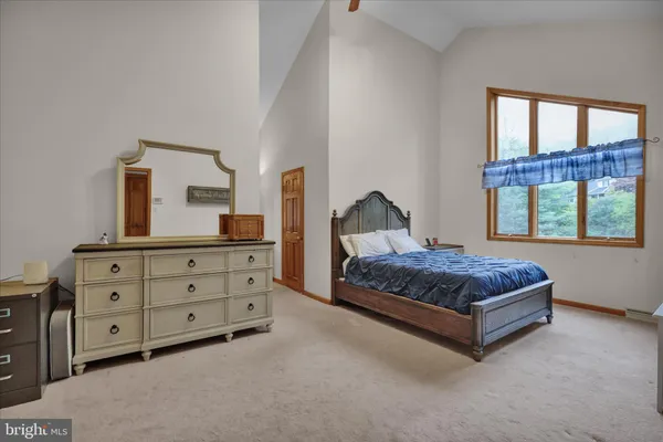 a view of a livingroom with furniture and a bookshelf