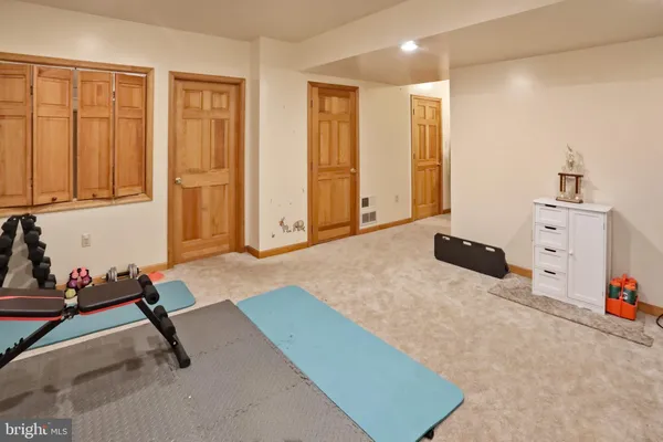 a room with gym equipment and a table