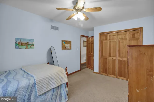 a bedroom with a bed and a table in it