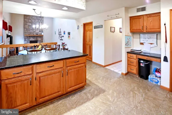 a kitchen with stainless steel appliances granite countertop a refrigerator a stove top oven a sink and dishwasher