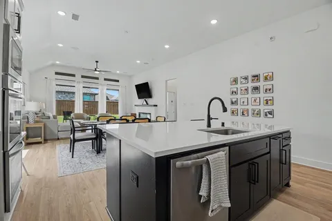 a kitchen with sink stove and cabinets