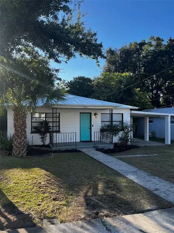 a view of a house with backyard patio and fire pit