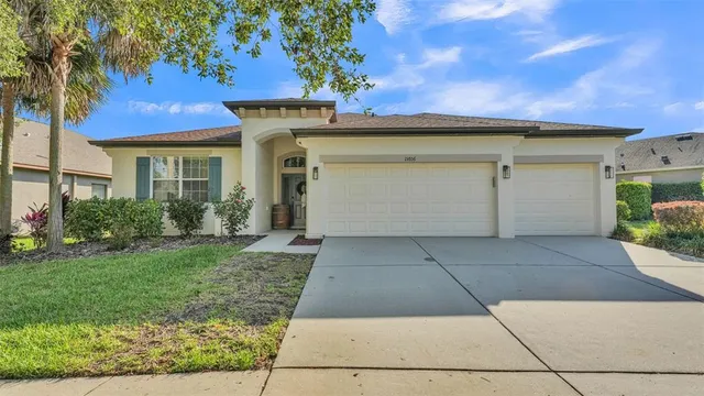a view of a white house with a yard