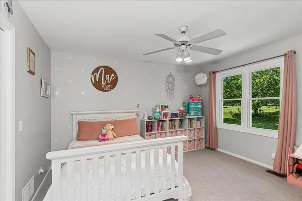 a bedroom with furniture and a large window