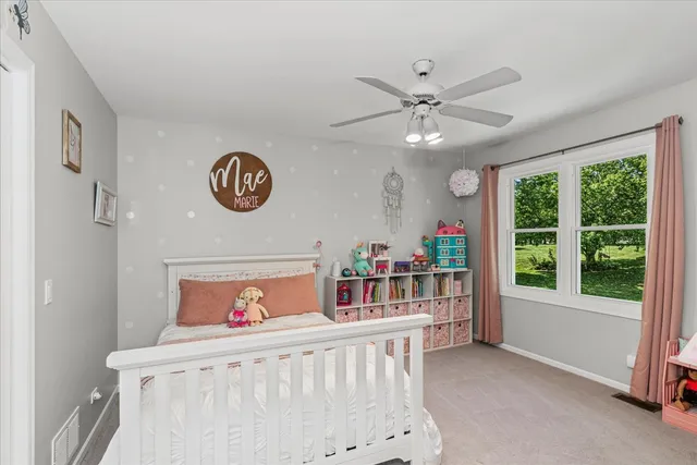 a bedroom with furniture and a large window