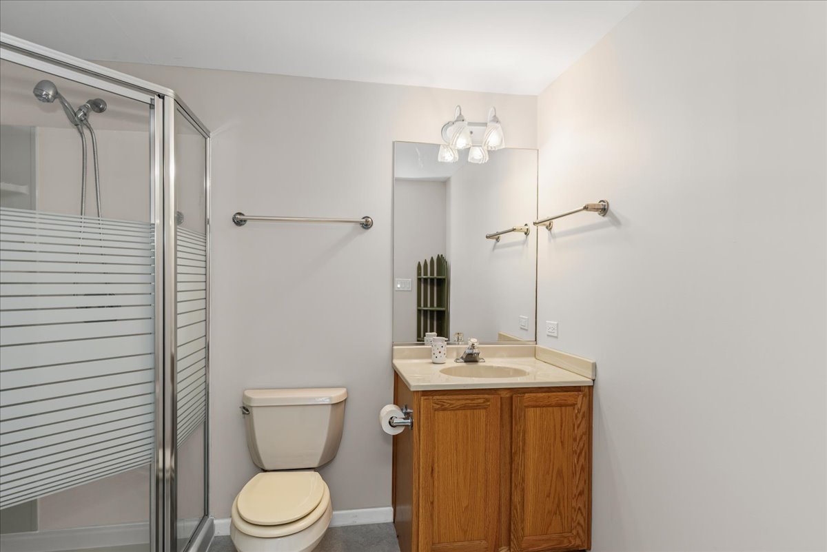 11111 Huron Drive Spring Grove, IL 60081 - Photo 15 of 20 a bathroom with a toilet a sink and mirror