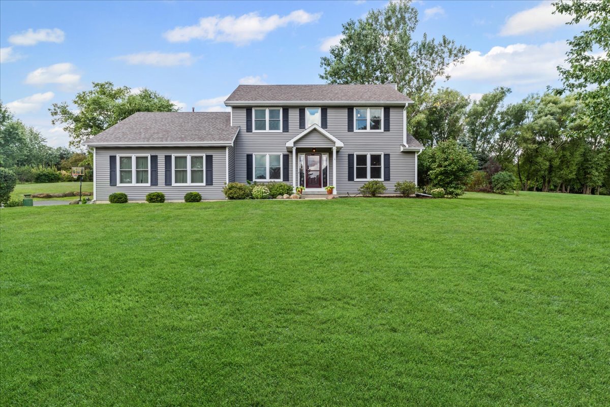 11111 Huron Drive Spring Grove, IL 60081 - Photo 20 of 20 a view of a house with a big yard and large trees