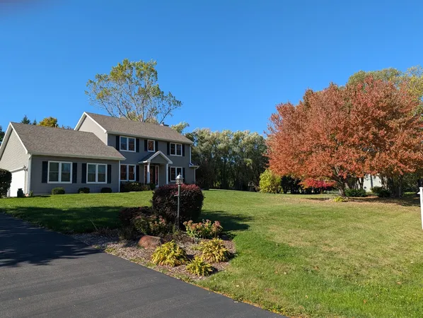 a front view of a house with a garden and pathway