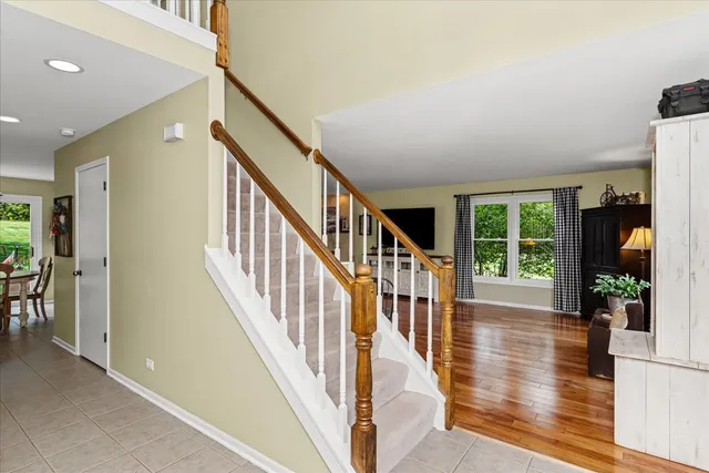 a view of an entryway with wooden floor and windows