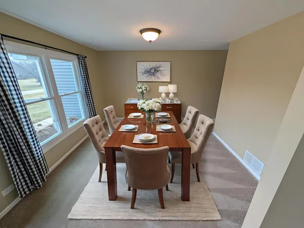 a view of a dining room with furniture window and wooden floor