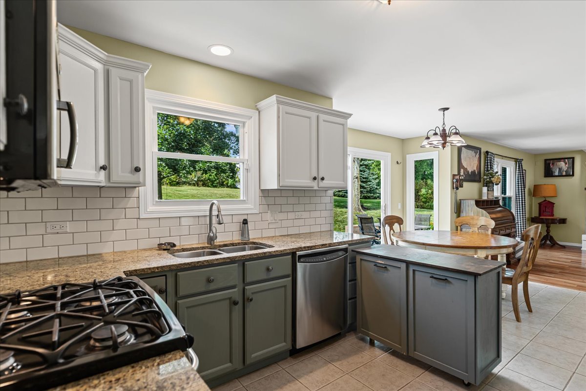 11111 Huron Drive Spring Grove, IL 60081 - Photo 7 of 20 a kitchen with a sink stove and cabinets