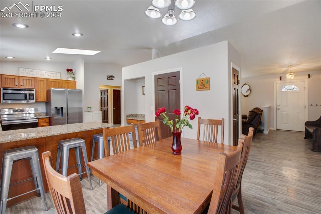 833 Spring Valley Drive Divide, CO 80814 - Photo 19 of 50 a view of a dining room with furniture and wooden floor