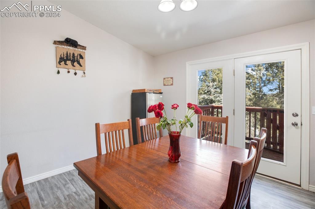 833 Spring Valley Drive Divide, CO 80814 - Photo 21 of 50 a view of a dining room with furniture window and wooden floor