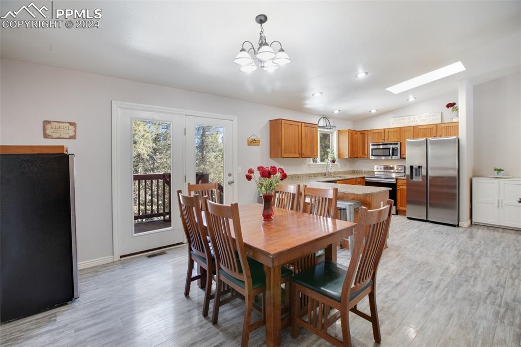 833 Spring Valley Drive Divide, CO 80814 - Photo 22 of 50 a view of a dining room with furniture and a chandelier