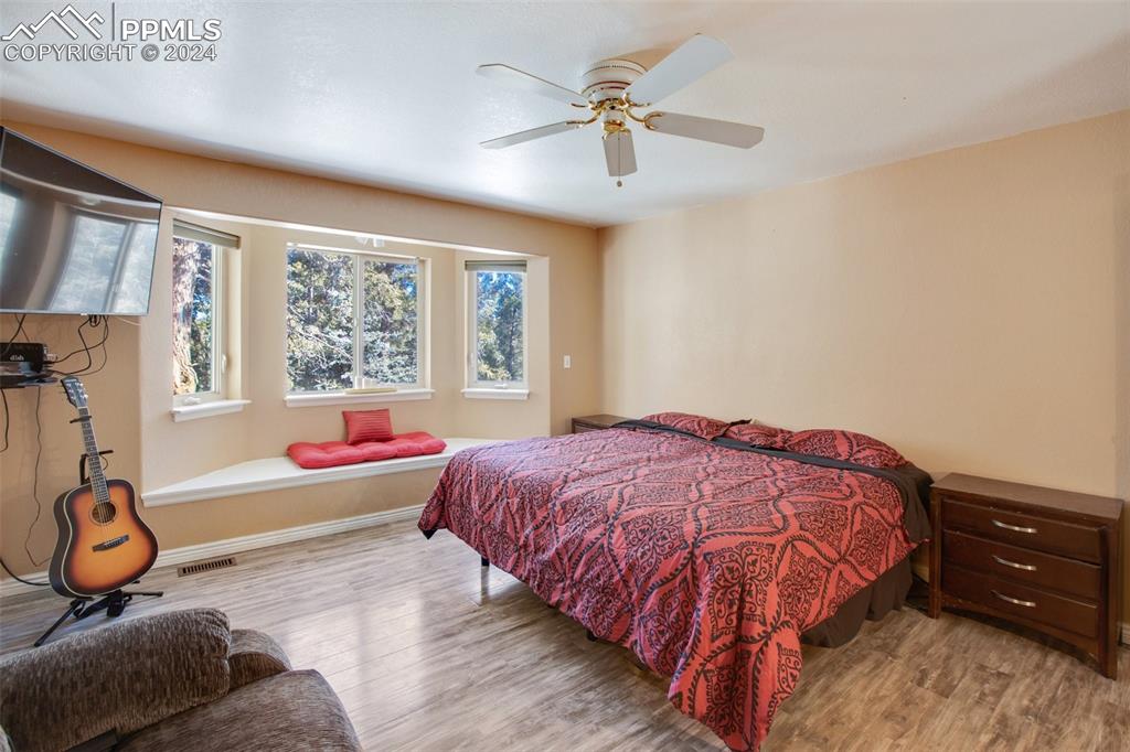 833 Spring Valley Drive Divide, CO 80814 - Photo 25 of 50 a bedroom with a bed and a chandelier