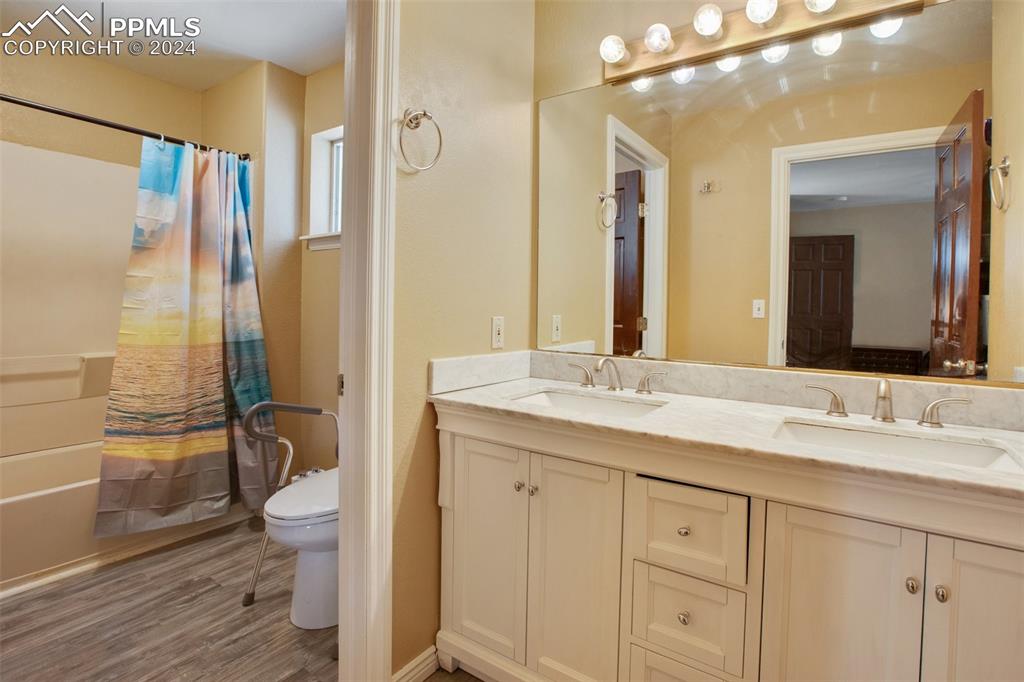 833 Spring Valley Drive Divide, CO 80814 - Photo 26 of 50 a bathroom with a granite countertop sink toilet and shower