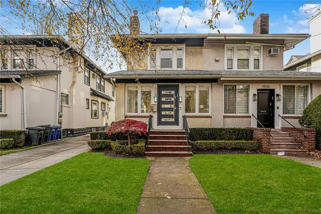 a front view of a house with a garden