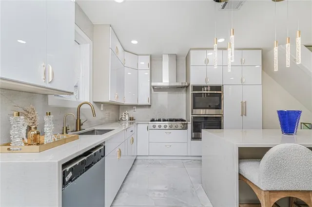 a kitchen with stainless steel appliances kitchen island granite countertop a sink and cabinets