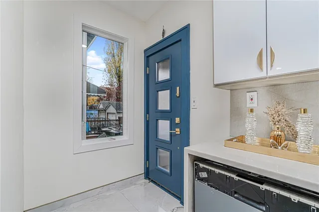 a kitchen with stainless steel appliances granite countertop a sink and a stove next to a window