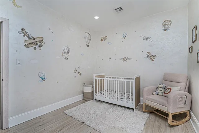 a view of a room with furniture and wooden floor