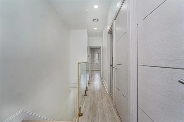 a view of a hallway with wooden floor