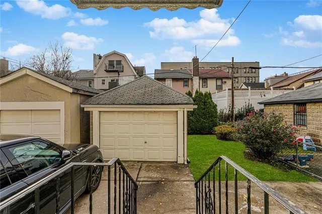 a front view of house with yard and car parked