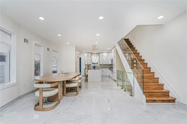 a room with lots of wooden furniture and a view of living room