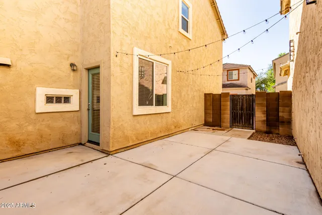 a view of a blue house with a street
