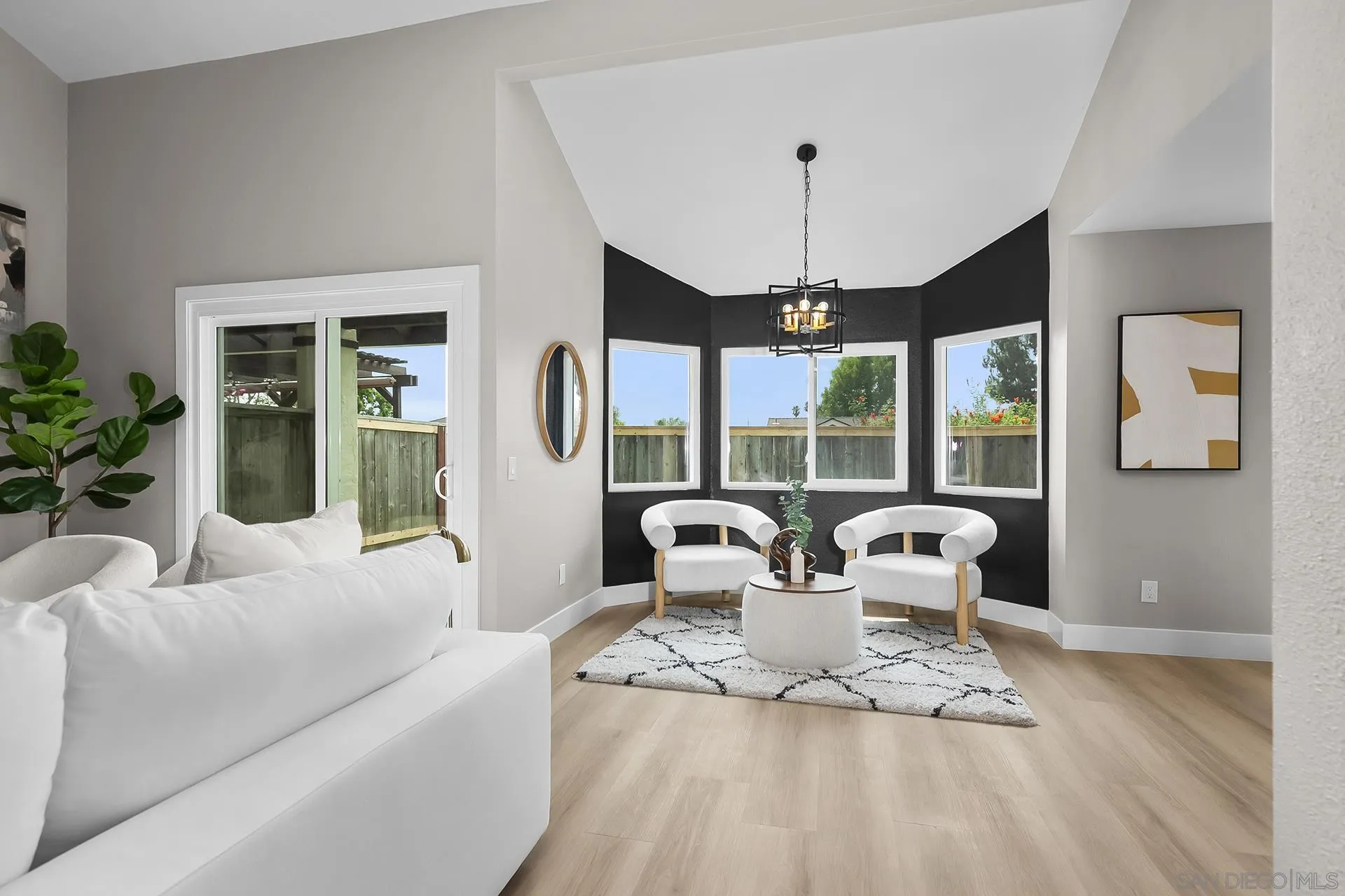 3226 Old Heather Road San Diego, CA 92111 - Photo 11 of 45 a living room with furniture large window and chandelier