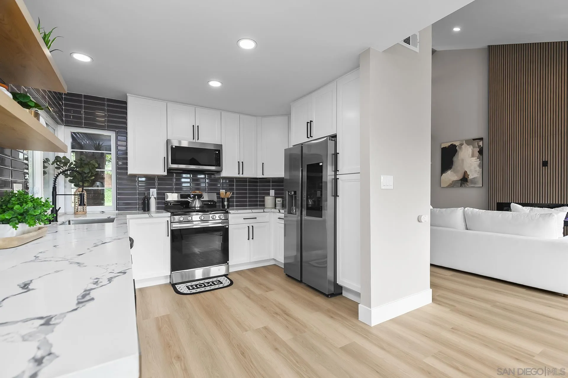3226 Old Heather Road San Diego, CA 92111 - Photo 18 of 45 a kitchen with a refrigerator a stove top oven a sink and cabinets
