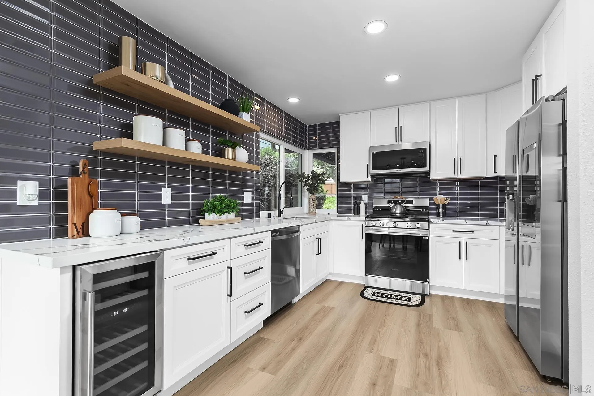 3226 Old Heather Road San Diego, CA 92111 - Photo 20 of 45 a kitchen with white cabinets and appliances