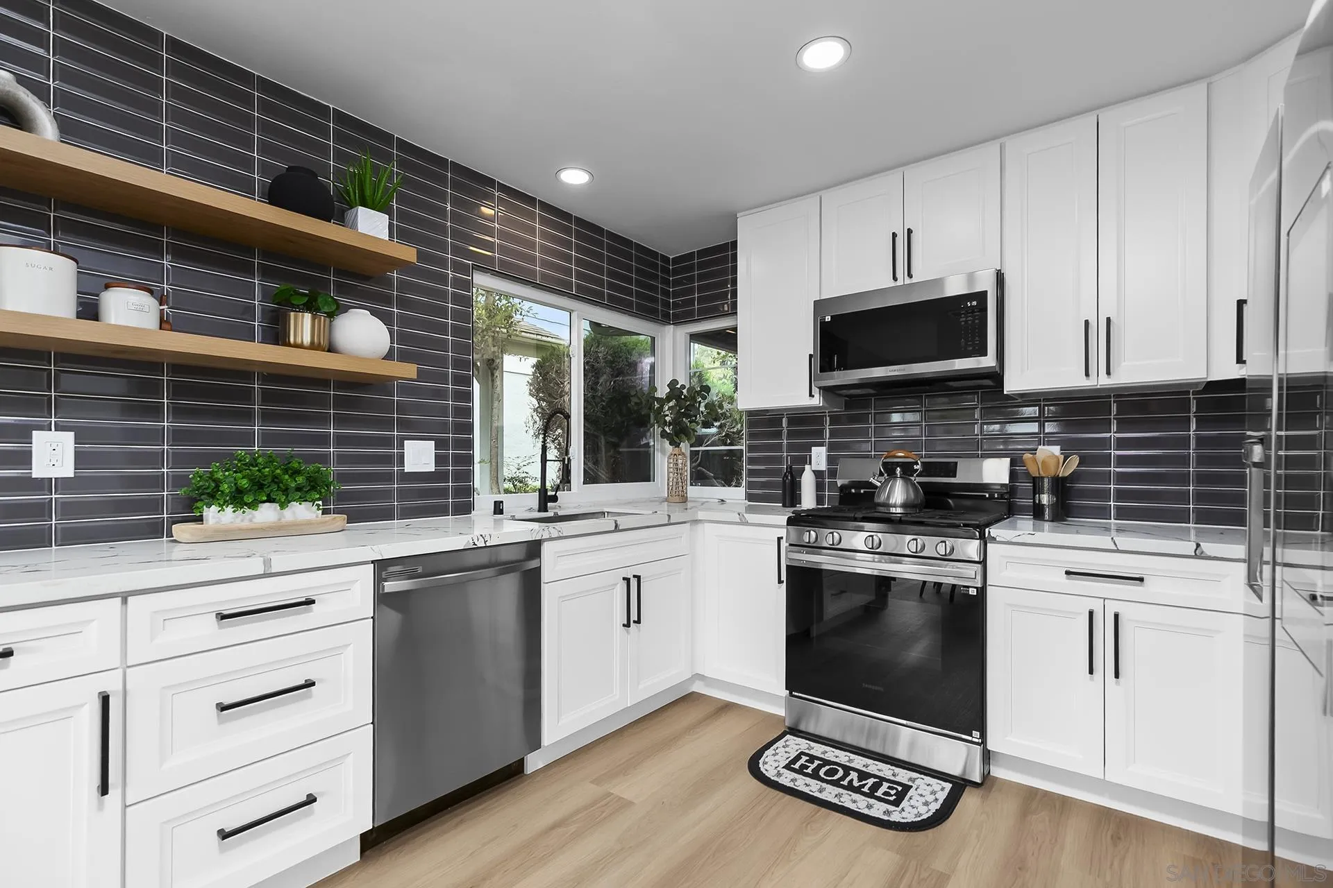 3226 Old Heather Road San Diego, CA 92111 - Photo 21 of 45 a kitchen with granite countertop a sink stainless steel appliances and cabinets