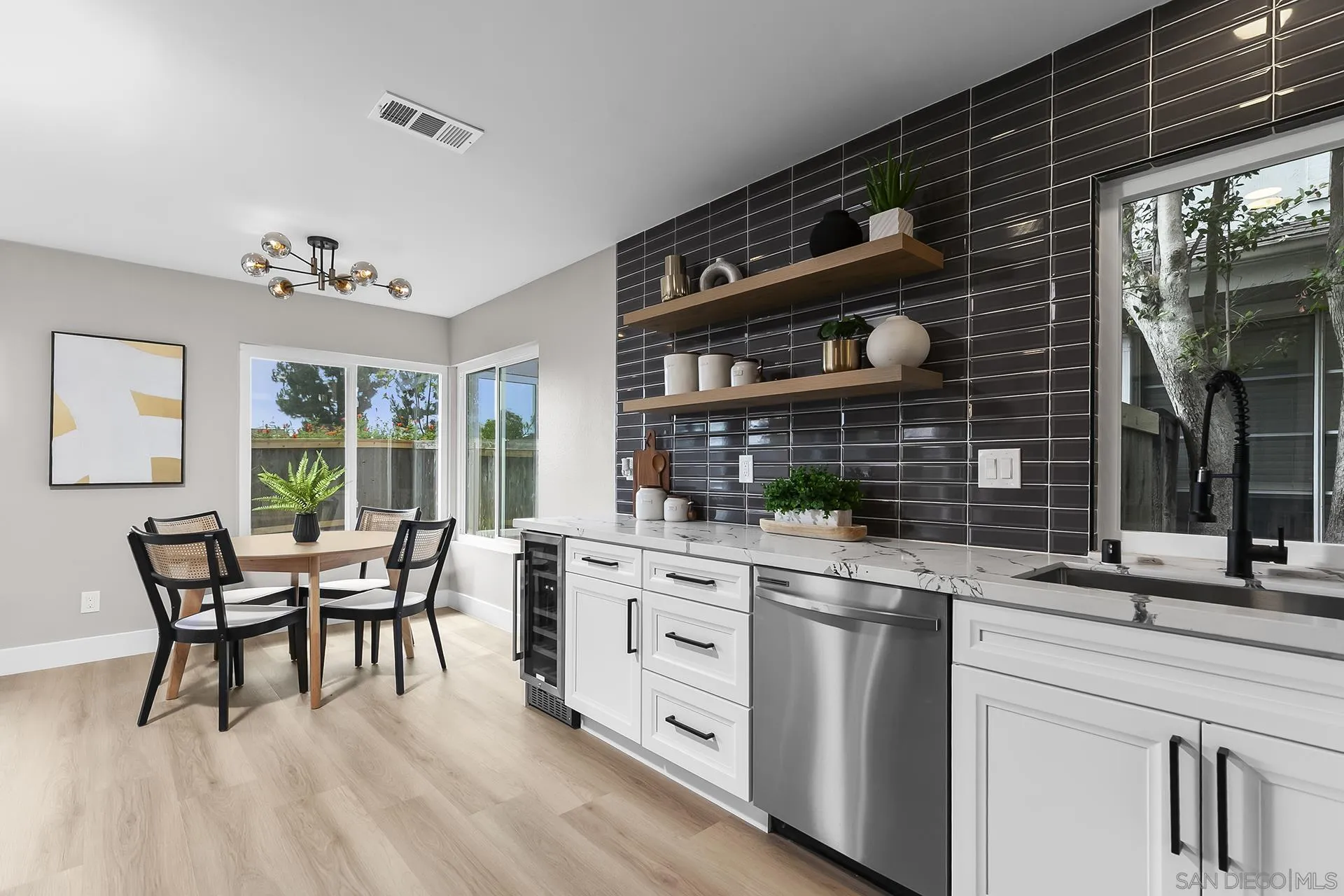 3226 Old Heather Road San Diego, CA 92111 - Photo 23 of 45 a open kitchen with white cabinets and wooden floor