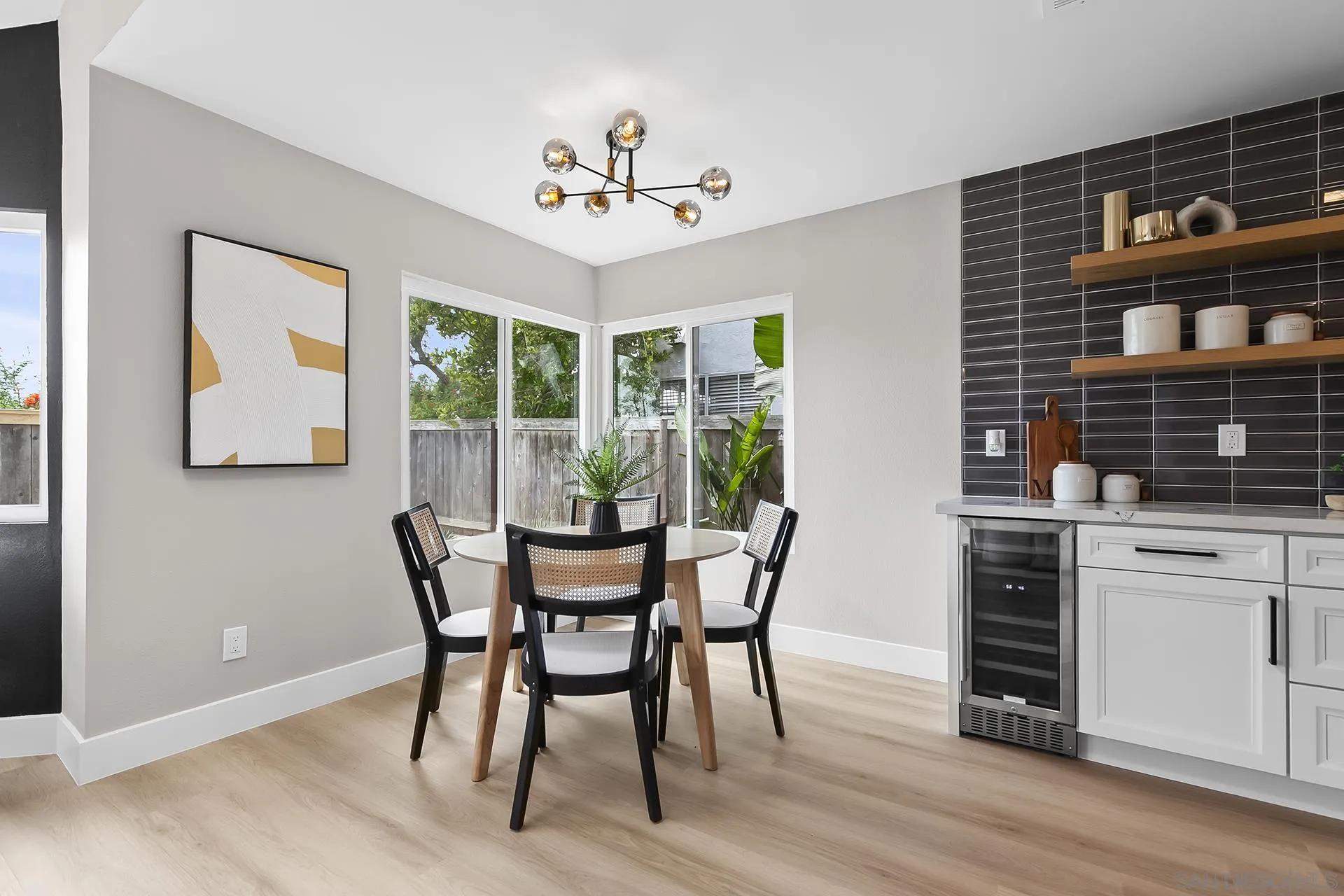 3226 Old Heather Road San Diego, CA 92111 - Photo 24 of 45 a dining room with wooden floor a chandelier a wooden table and chairs