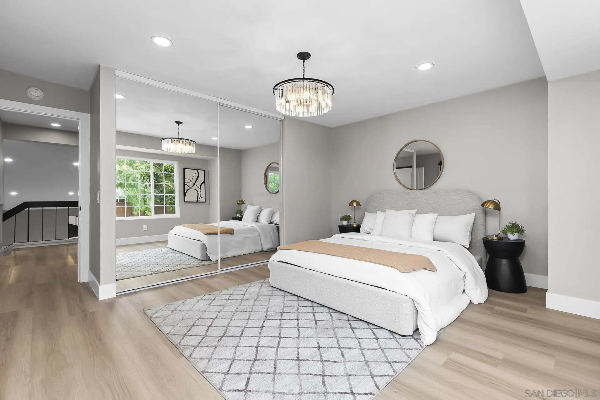 3226 Old Heather Road San Diego, CA 92111 - Photo 27 of 45 a bedroom with a large bed and a chandelier