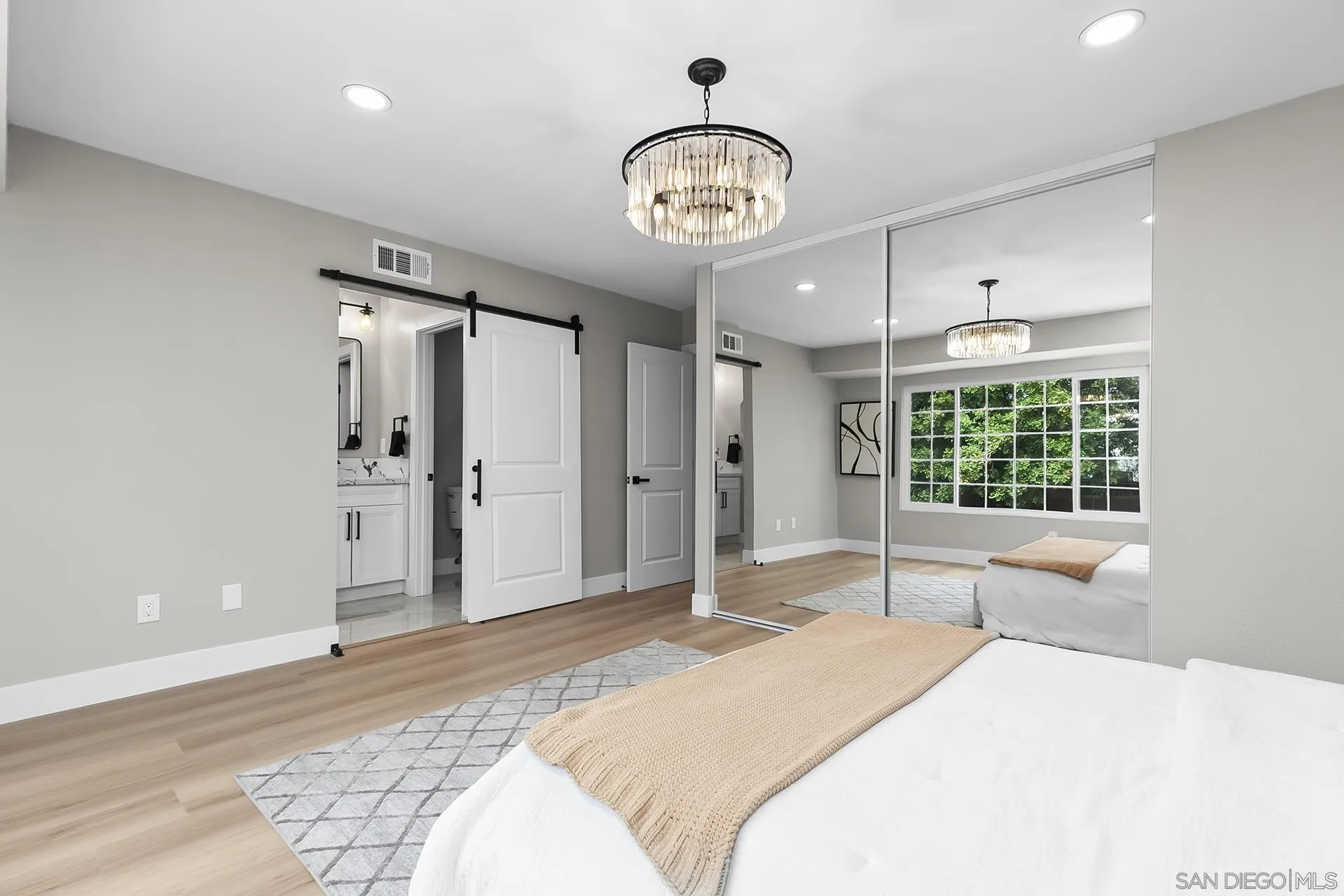 3226 Old Heather Road San Diego, CA 92111 - Photo 28 of 45 a spacious bedroom with a large bed and chandelier