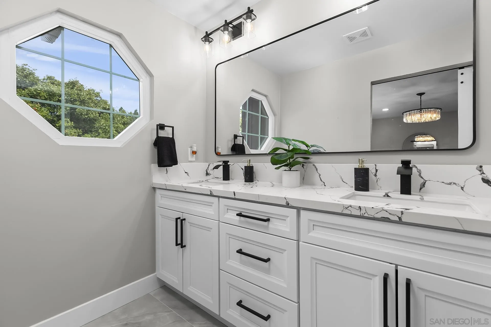 3226 Old Heather Road San Diego, CA 92111 - Photo 30 of 45 a bathroom with a sink and a mirror