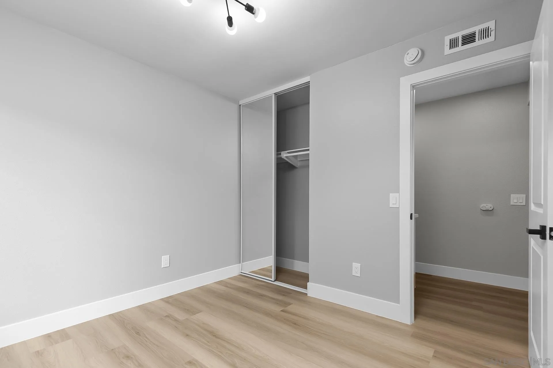 3226 Old Heather Road San Diego, CA 92111 - Photo 36 of 45 a view of an empty room with wooden floor