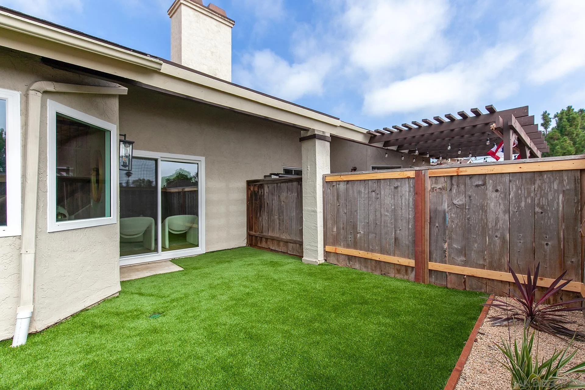 3226 Old Heather Road San Diego, CA 92111 - Photo 45 of 45 a view of a backyard with potted plants and wooden fence