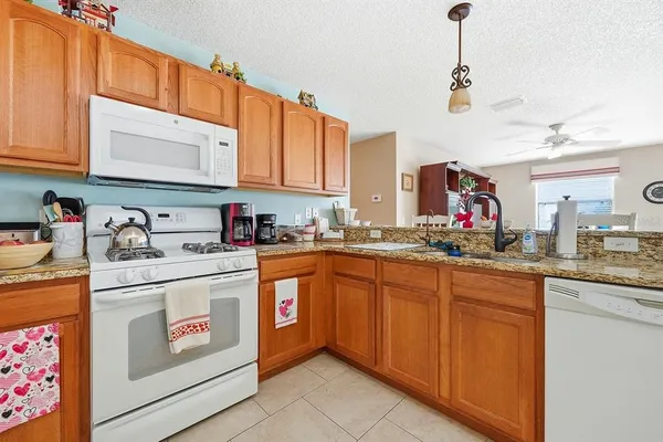 a kitchen with stainless steel appliances granite countertop a sink and cabinets