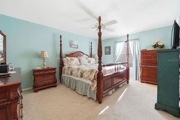 a bedroom with a bed and a chandelier