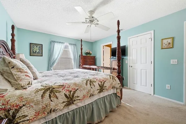 a bedroom with a bed dresser and a window