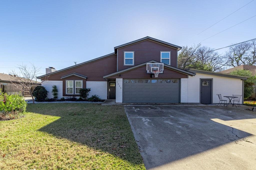 a front view of a house with a yard and garage
